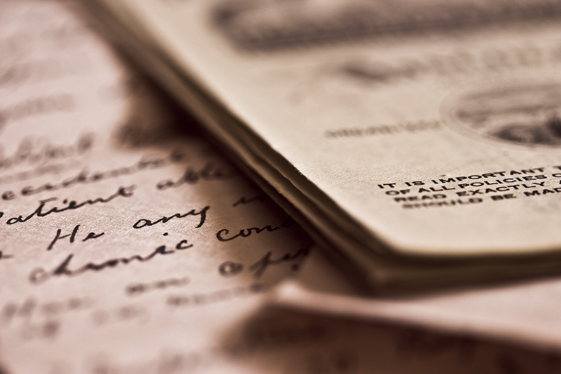 A closeup of a handwritten letter and assorted documents.