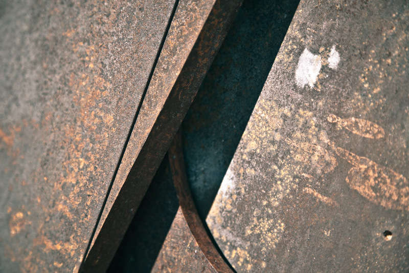 Rusty metal. Straight lines. One curve.