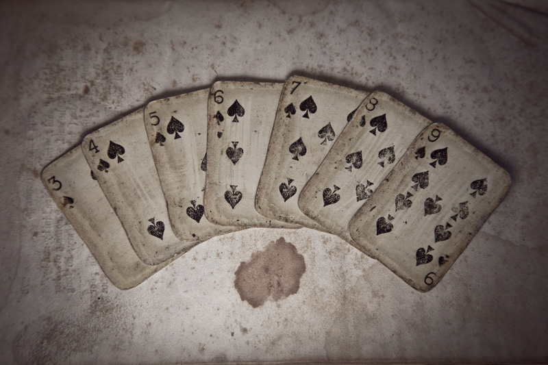 Very old miniature cards, showing the 3 of spades through the 9 of spades.