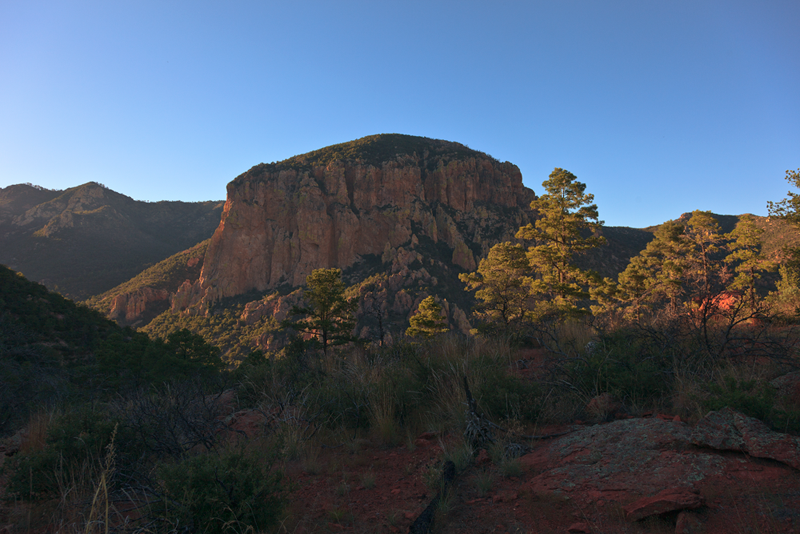 Evening sunlight against a peak in the Chiricahua Mountains, viewed from the Red Rocks along the Burro Trail.