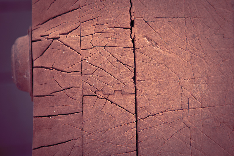 The surface of an old, weathered, well-used butcher's block.