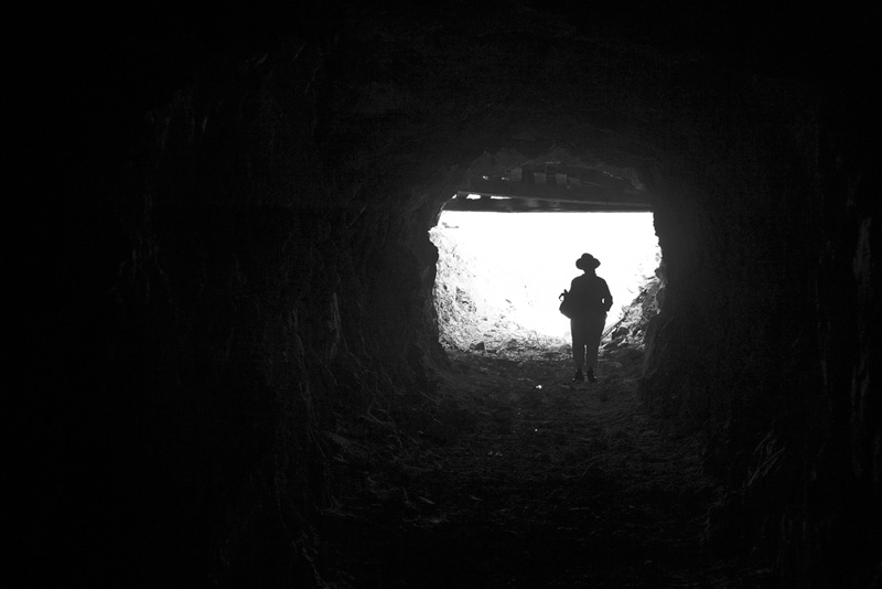 Standing at the entrance of a mine adit.