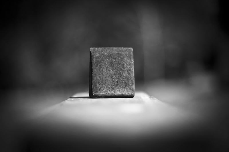 A metal cube atop a non-cube.