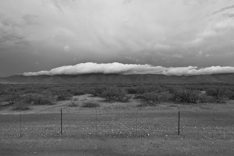 A layer of cloud between mountain and sky.