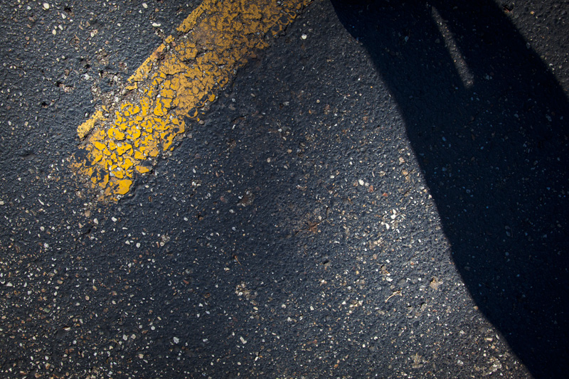 A weathered yellow stripe from a parking lot.