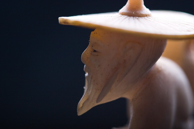 A miniature statue of a Chinese man.