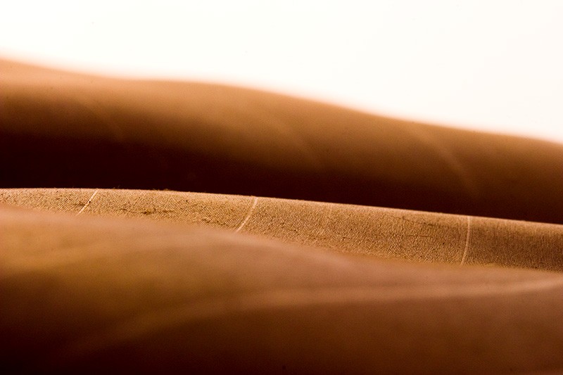 A vinyl record rippled from being left in the sun, resembling a landscape of agricultural fields spanning rolling hills.