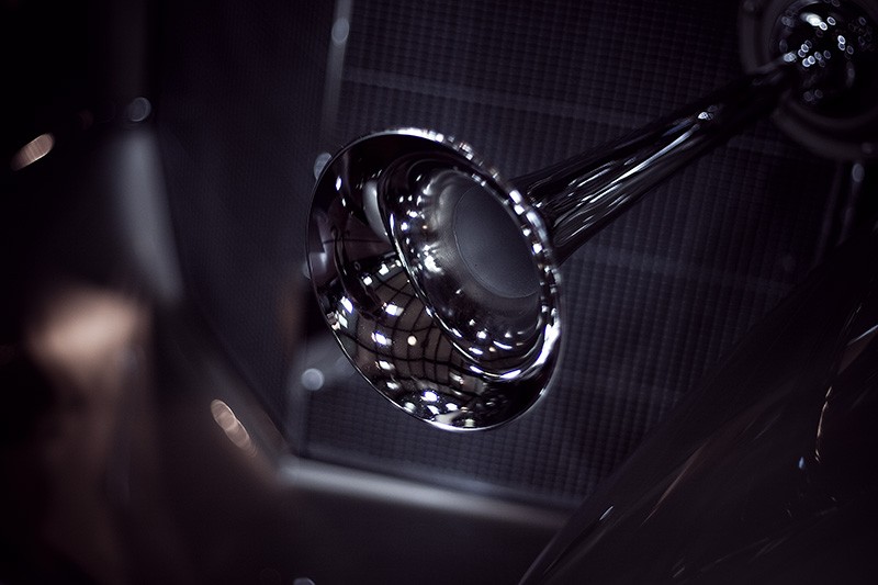 A chrome horn on an antique car.