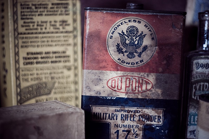 Several old bottles, cans and jars.