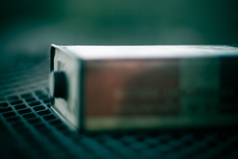 An antique gunpowder tin lit by the dusk sky.