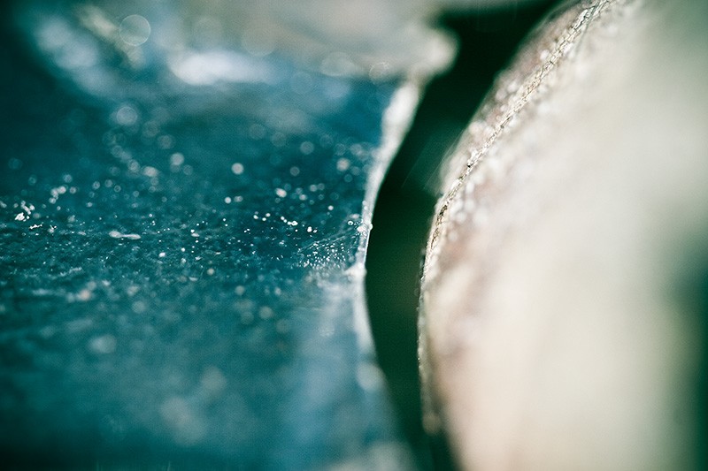 A narrow gap between a sheet of ice and a stone.