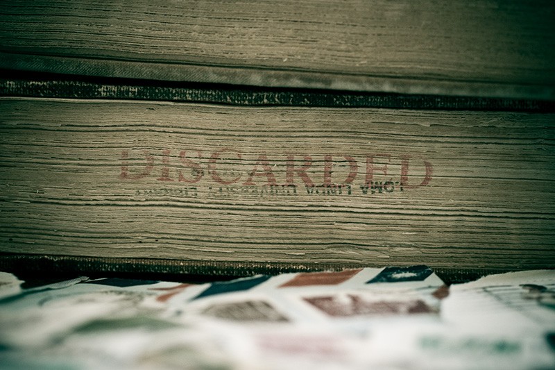 A discarded book and some postage stamps.