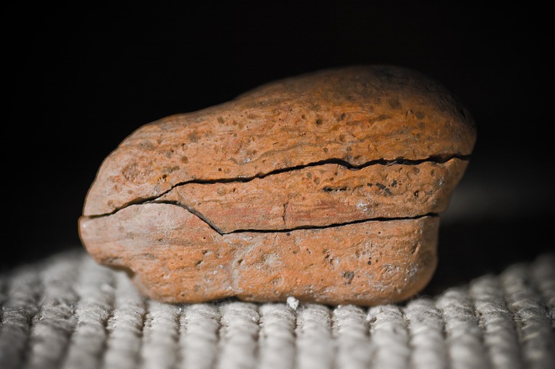 An orange rock cracked into three sections.