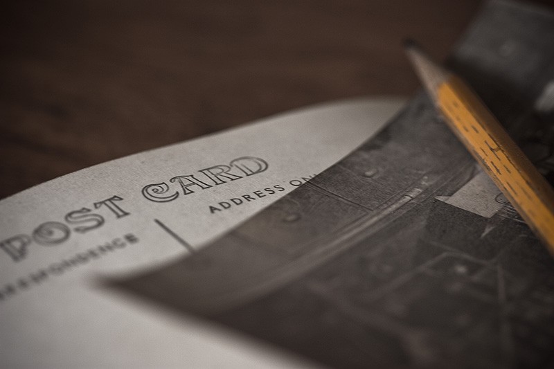Two post cards and a yellow pencil.