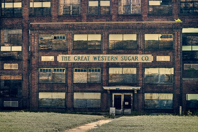 An abandoned warehouse in Colorado with a sign saying "The Great Western Sugar Co."