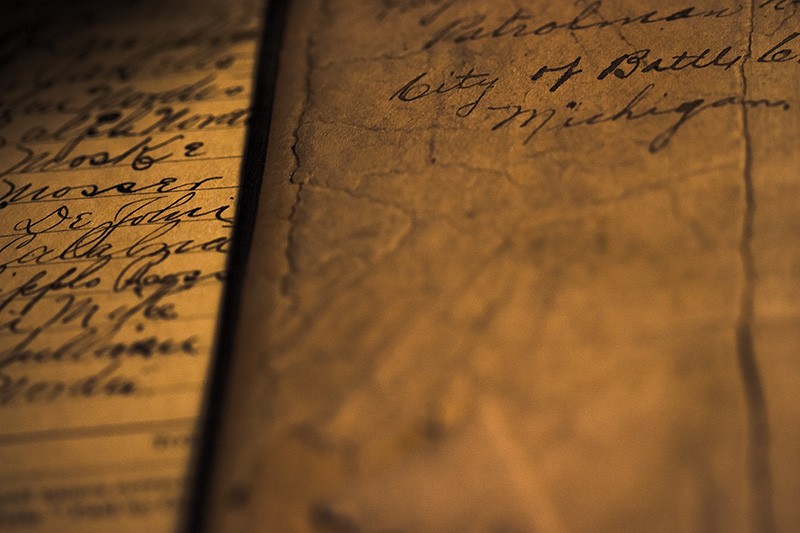 Ink handwriting on extremely cracked and aged paper.