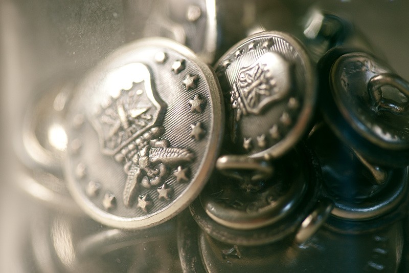 A jar full of U.S. Military buttons.