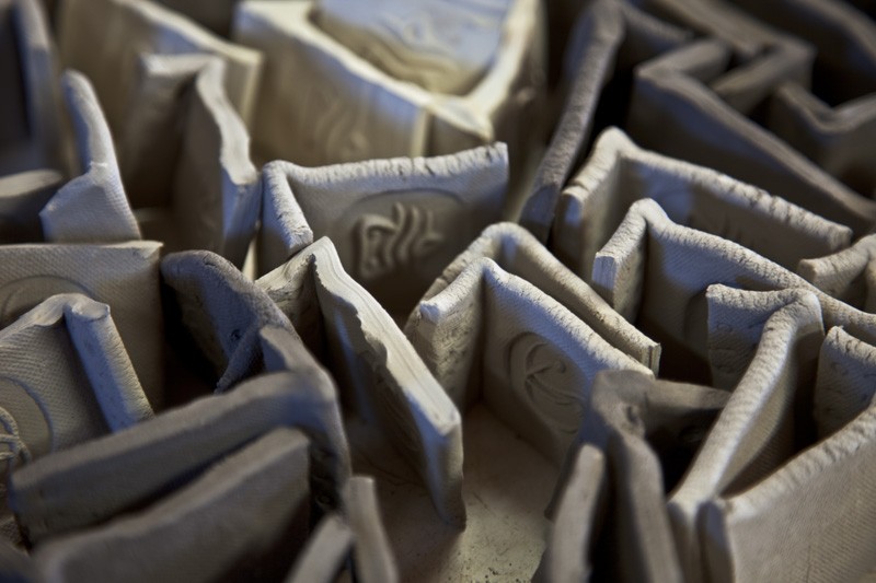 A collection of ceramic test pieces drying.