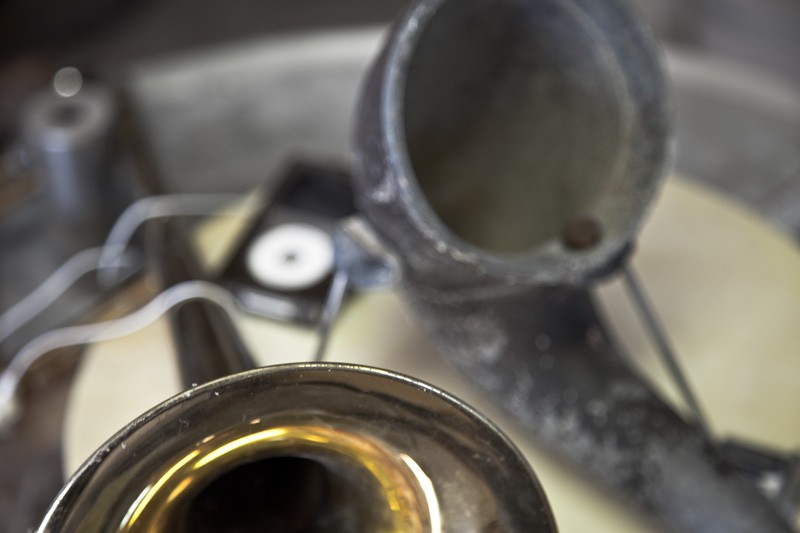 An iPod playing music through standard iPod earbuds inserted into the end of two horns, which act as acoustic amplifiers.