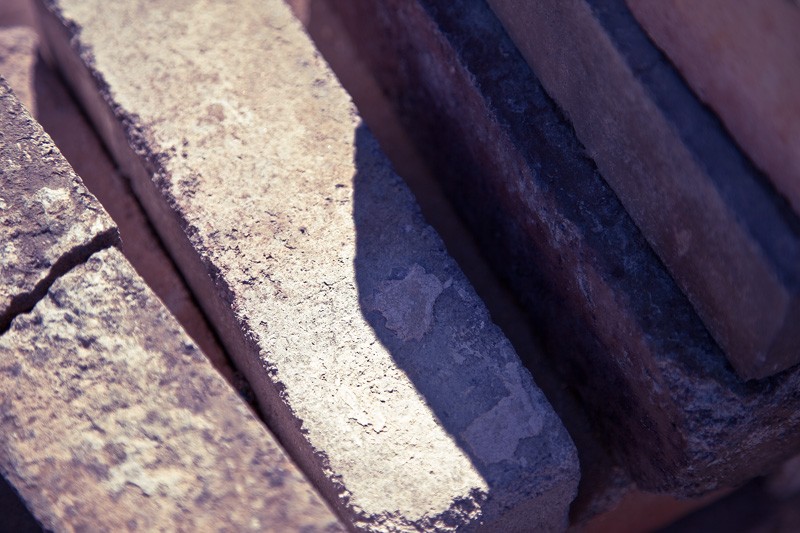 Stacked bricks, one of them broken.