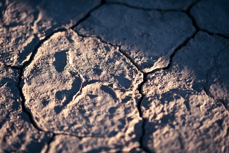 Cracked earth in twilight.