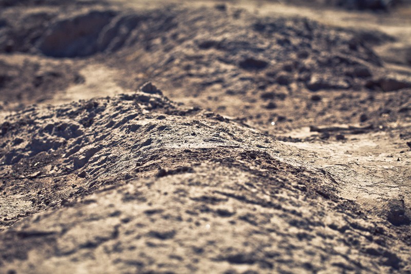 Rough, eroded dirt terrain.