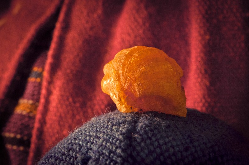 A clump of dried sap sitting atop cloth juggling balls.