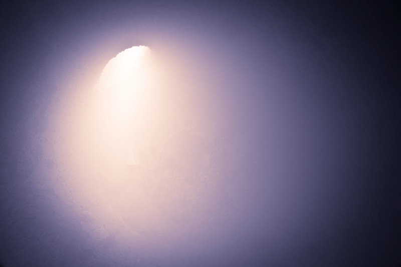A shaft of light entering into a large chamber.