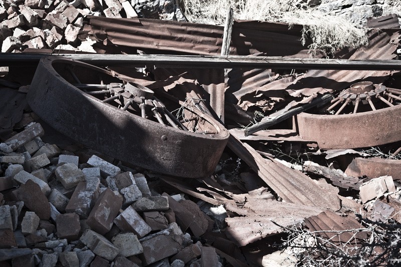 A pile of wheels and corrugated metal.
