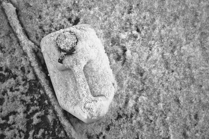 A gas can covered in snow.