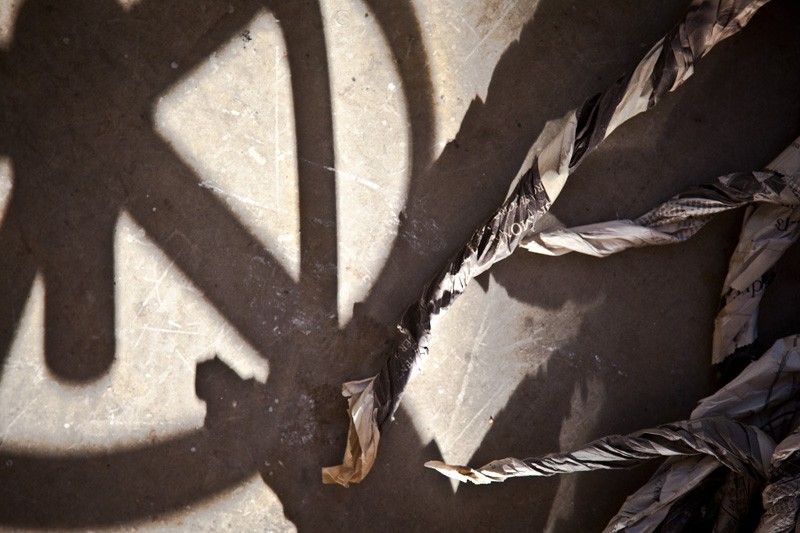 Shadows, concrete and newspaper.