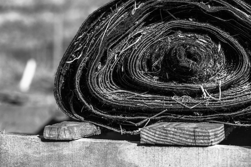 Large roll of fabric on a wooden pallet.