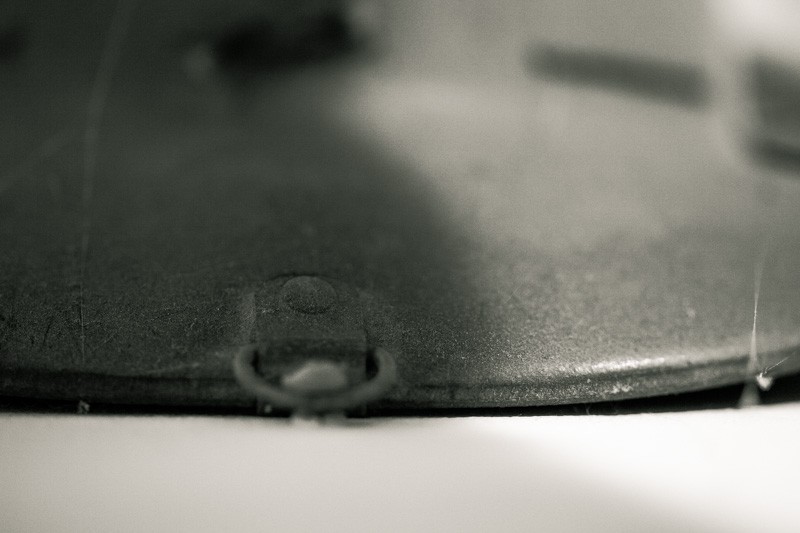 A fireman's helmet hanging on a wall.