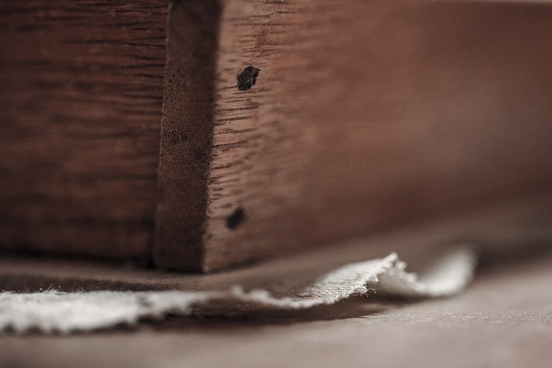 A box on a table with a doily between.