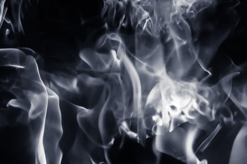 A fire burning inside a wood stove.