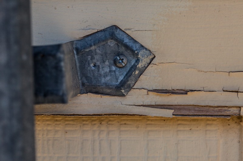 A bracket with only one of two planned holes in use.