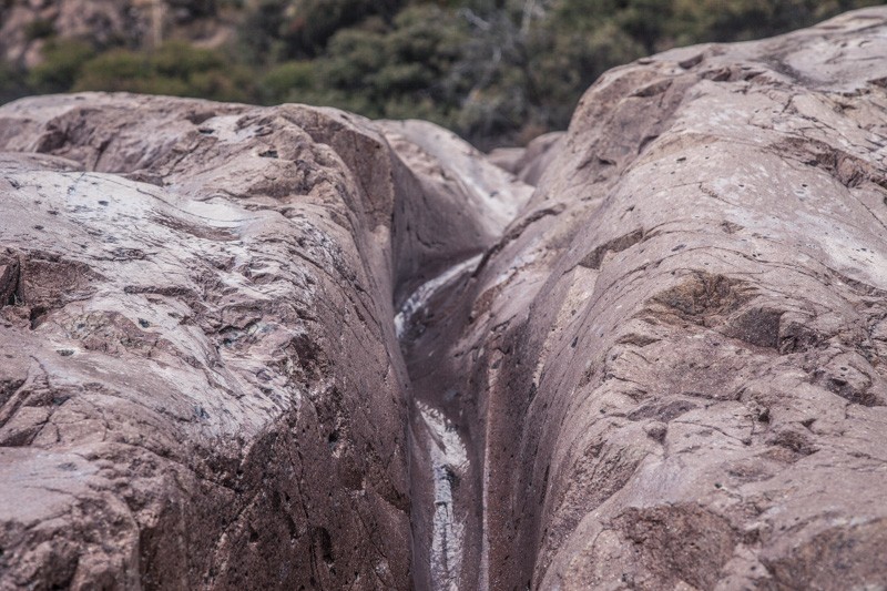 A deep channel cut into rock by water.