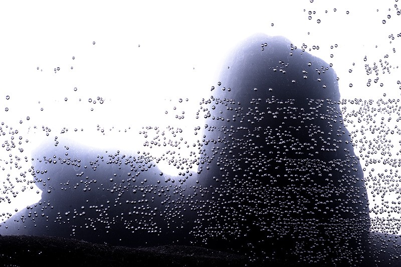 Mist-covered mountains with bubbles in the foreground.