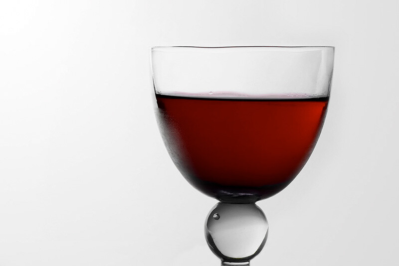 A glass with cranberry juice.